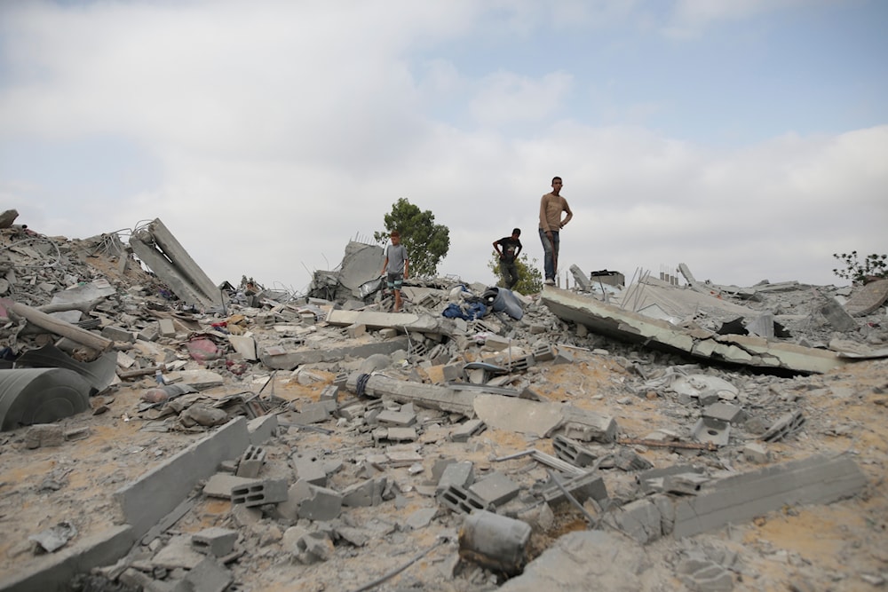 Palestinians look at the destruction after an Israeli airstrike in Khan Younis, Gaza Strip, occupied Palestine, June 3, 2024 (AP)