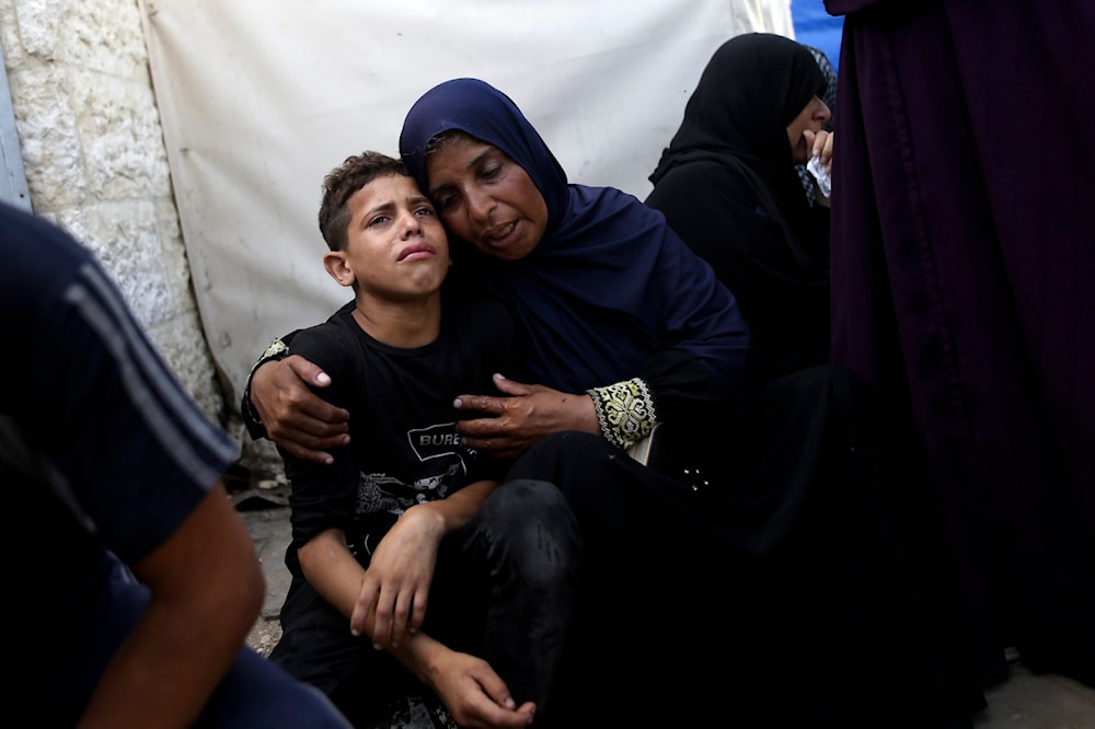 Palestinians mourn their relatives killed in the Israeli bombardment of the Gaza Strip at al-Aqsa Hospital in Deir al-Balah, central Gaza Strip, Saturday, June 8, 2024. (AP)