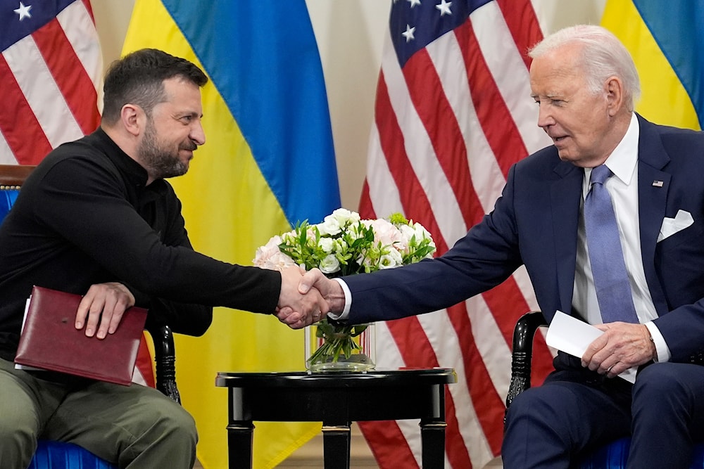 U.S. President Joe Biden shakes hands with Ukrainian President Volodymyr Zelenskyy in Paris, Friday, June 7, 2024. (AP)