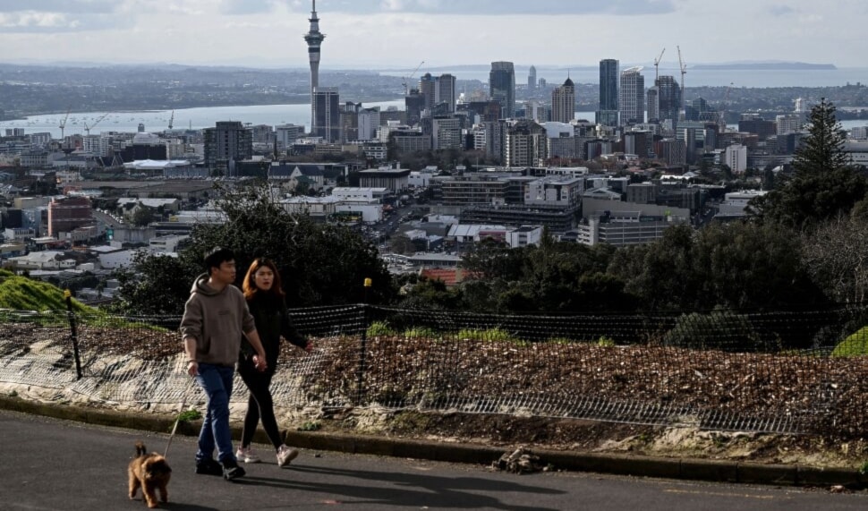 Residents walk their dog toward the summit of Mount Eden, a dormant volcano, in Auckland, New Zealand. (AFP)