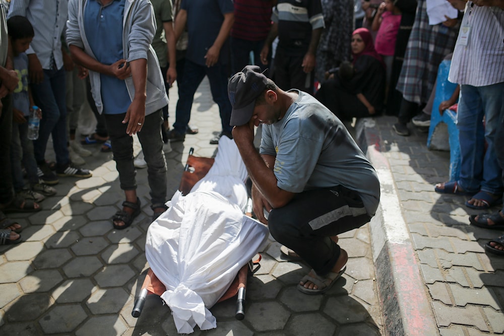 Palestinians mourn over the bodies of relatives killed in an Israeli airstrike, outside the morgue in Al-Aqsa Martyrs Hospital in Deir al Balah, the Gaza Strip, on June 10, 2024. (AP)