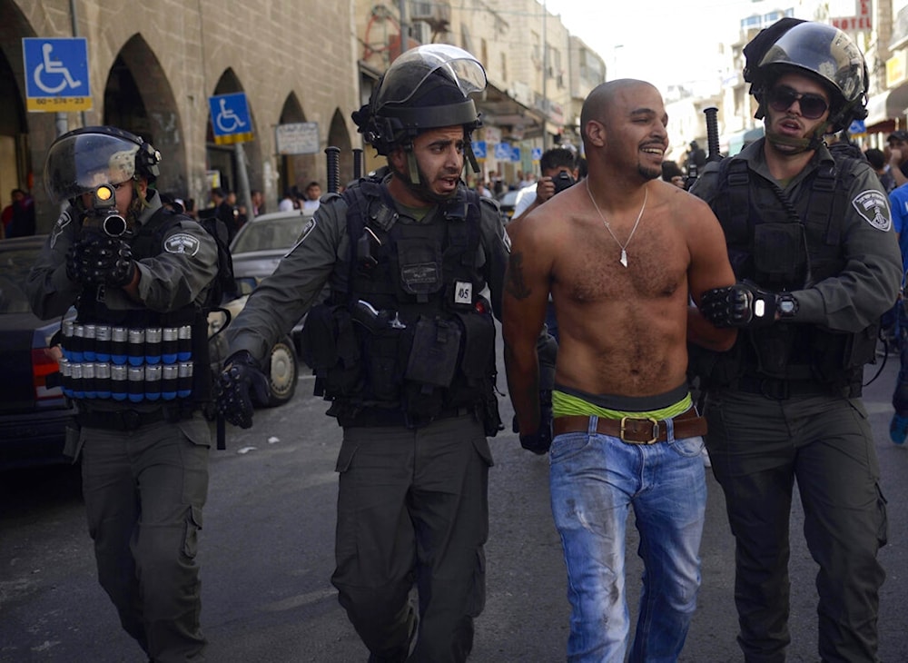 Israeli occupation forces detain a Palestinian during a Land Day protest in occupied al-Quds, Palestine, on Saturday, March 29, 2014. (AP)