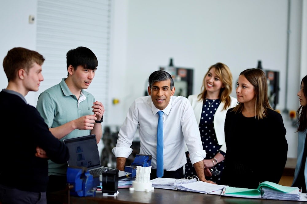 Britain's Prime Minister and Conservative Party leader Rishi Sunak speaks with students during a visit of University Technical College (UTC) in Silverstone, England, Tuesday June 11, 2024 (AP)