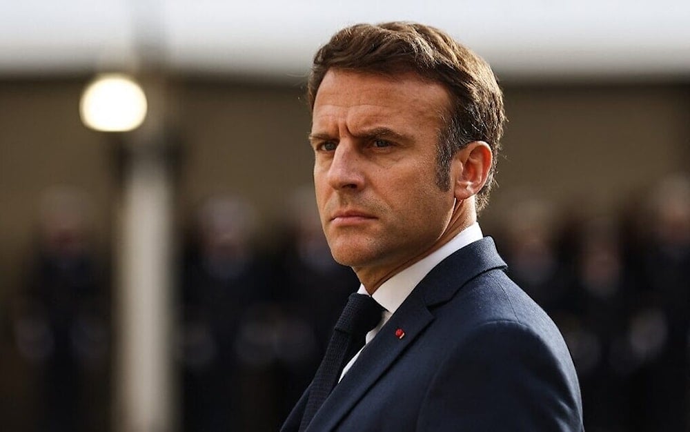 French President Emmanuel Macron looks on as he attends a tribute ceremony to veterans of the Algerian War, at the Hotel National des Invalides, in Paris on October 18, 2022. (AFP)