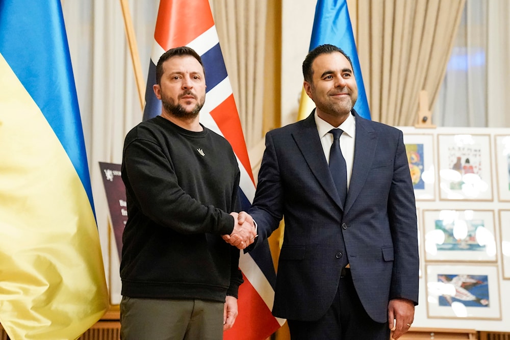 Ukrainian President Volodymyr Zelenskyy, left, and Norway's Parliament Speaker Masud Gharahkhani shake hands in the Storting in Oslo, Norway, Wednesday Dec. 13, 2023. (AP)