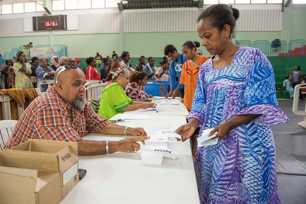 A woman participates in a referendum in Noumea, New Caledonia, Sunday, Oct. 4, 2020, whether voters choose independence from France. (AP)