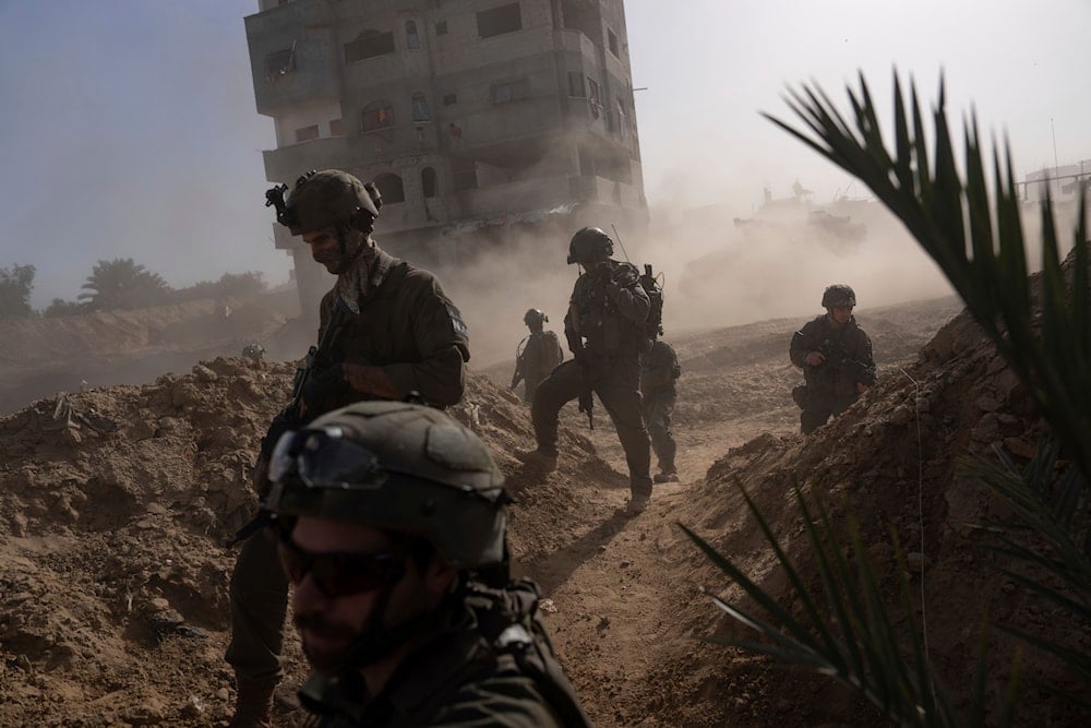 Israeli soldiers take up positions during a ground operation in Khan Younis, Gaza Strip on January 10, 2024 (AP)