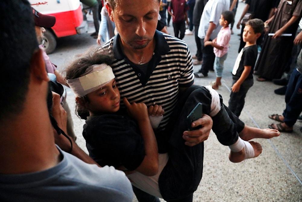 A Palestinian child wounded in an Israeli bombardment on a residential building owned by the Jabr family in Bureij refugee camp, is brought to al-Aqsa Martyrs Hospital in Deir al Balah, central Gaza Strip, Wednesday, June 12, 2024. (AP)