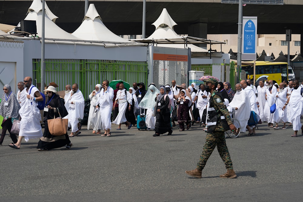 Muslim pilgrims arrive at the Mina tent camp during the annual Hajj pilgrimage, near the holy city of Mecca, Saudi Arabia, June 14, 2024 (AP)