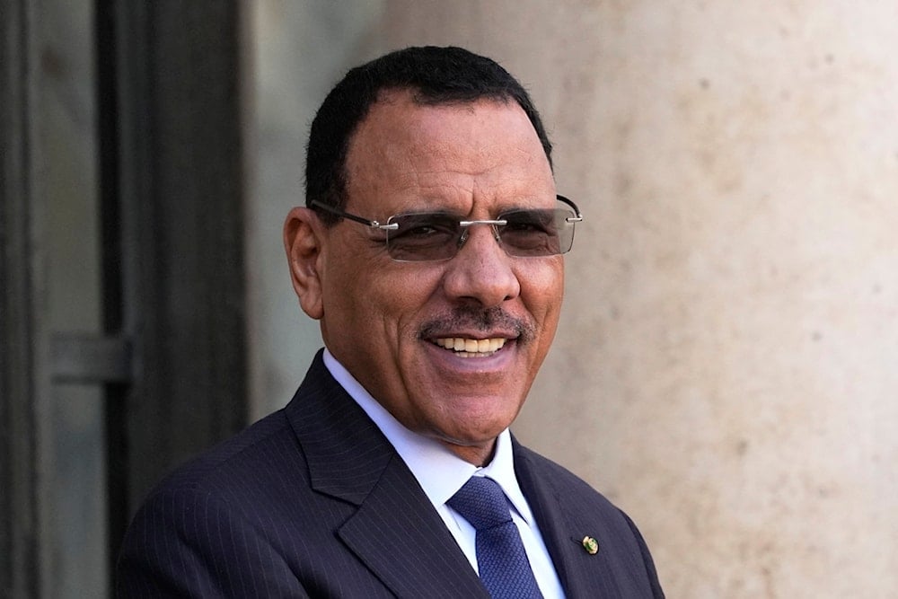 Niger's ousted President Mohamed Bazoum smiles before a working lunch with French President Emmanuel Macron, Feb. 16, 2023 at the Elysee Palace in Paris (AP)