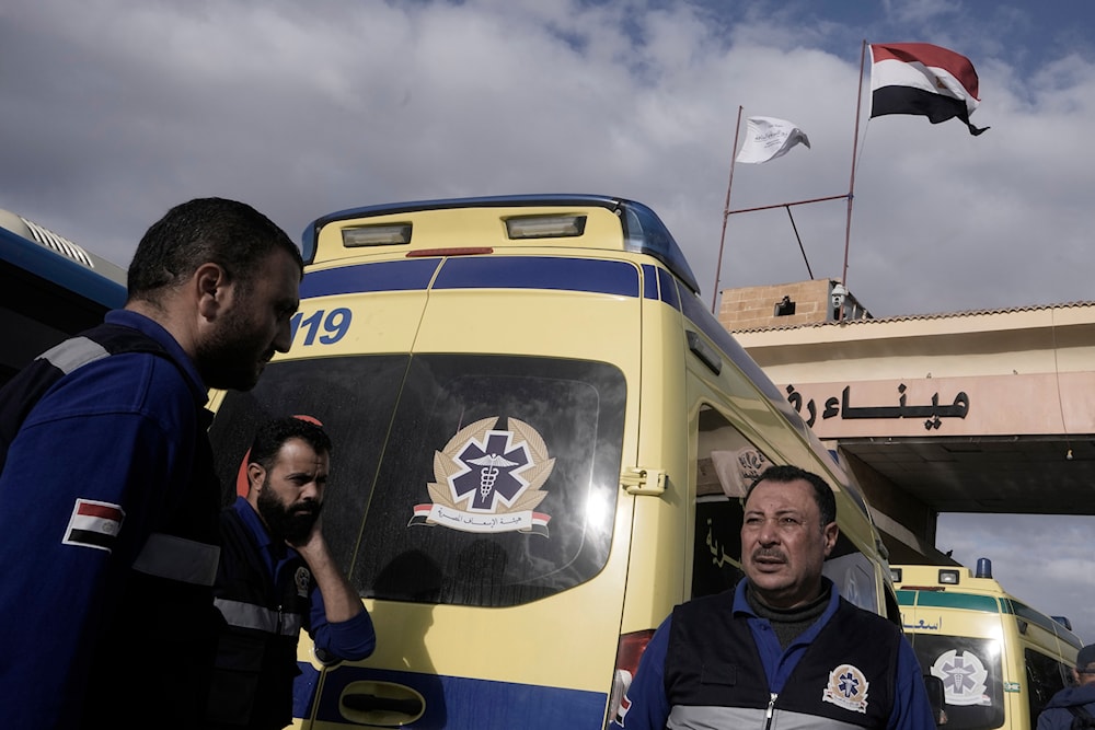 Egyptian ambulances drivers, carrying bodies of Palestinians who died at Egyptian hospital after injuries from the war in Gaza, wait to cross Rafah crossing port, Egypt, on the way to Gaza Strip, occupied Palestine, November 27, 2023