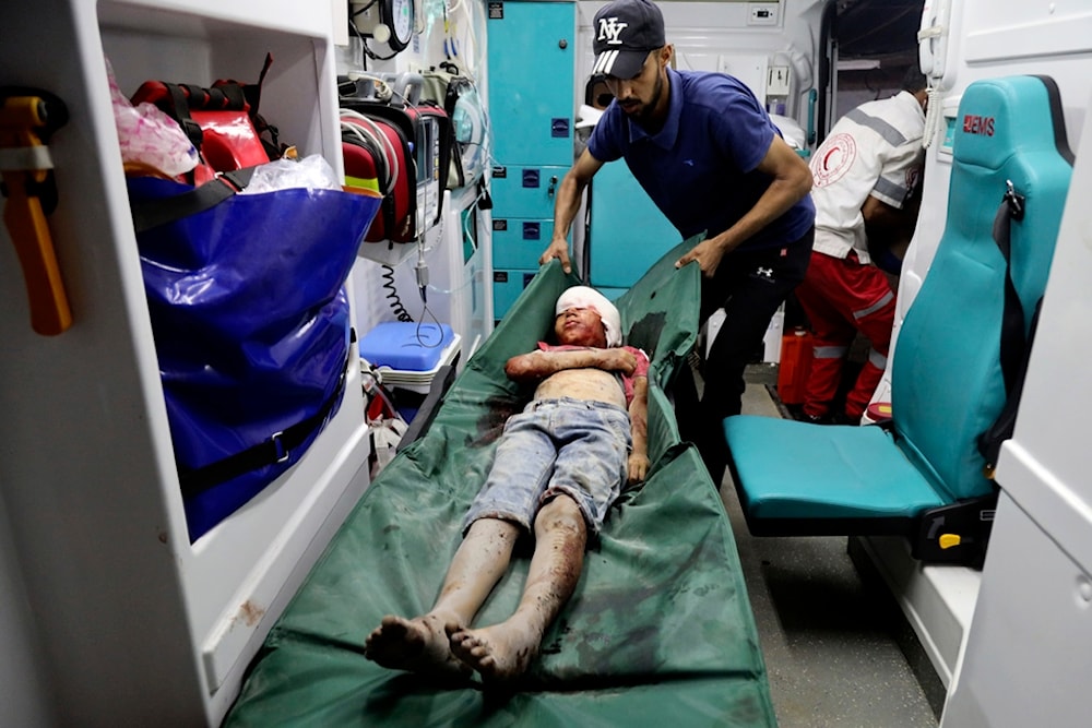 A Palestinian child wounded in an Israeli bombardment on a residential apartment owned by the Abo-Jalamo family in Bureij refugee camp, is brought to al-Aqsa Martyrs Hospital in Deir al-Balah, central Gaza Strip, early Friday, June 14, 2024. (AP)