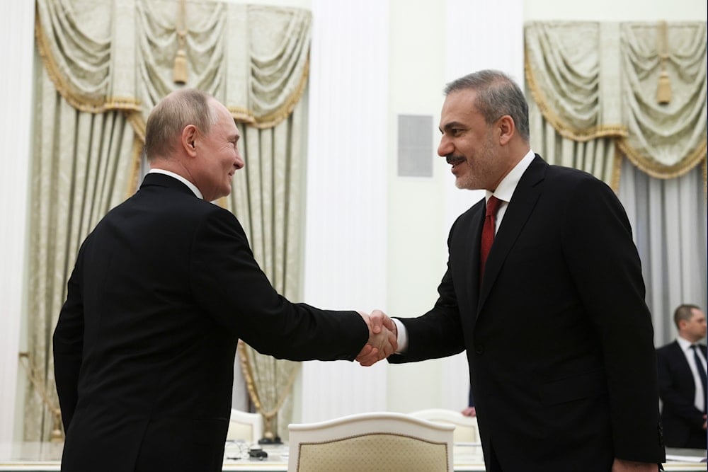 Russian President Vladimir Putin, left, and Turkey's Foreign Minister Hakan Fidan shake hands during their meeting at the Kremlin in Moscow, Russia, on June 11, 2024. (AP)