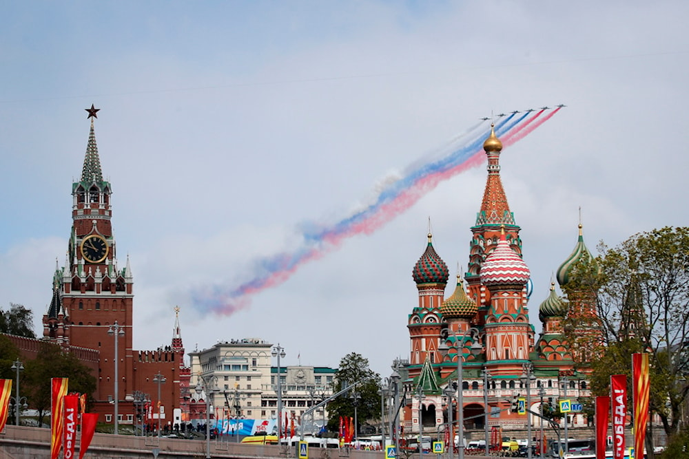 Russian Air Force Su-25 jets fly over Red Square leaving trails of smoke in the colours of the Russian national flag during the Victory Day military parade in Moscow, Russia, May 9, 2024. (AP)