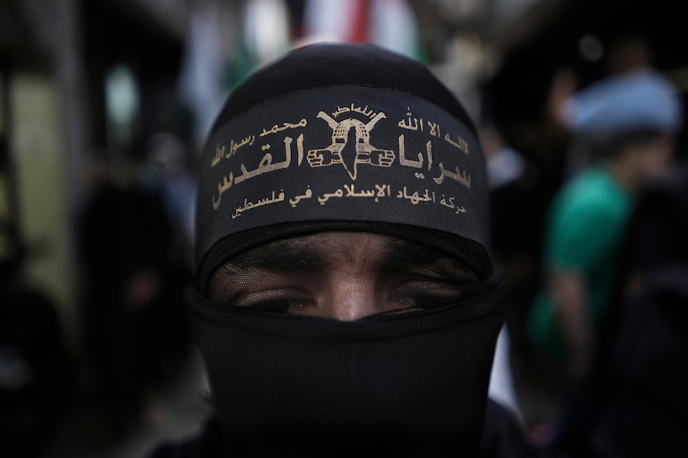 A member of al-Quds Brigades, the military wing of the Palestinian Islamic Jihad walks during a protest in solidarity with the Palestinian people in Gaza, at the Palestinian refugee camp of Chatila in Beirut, Lebanon, May 11, 2024 (AP)