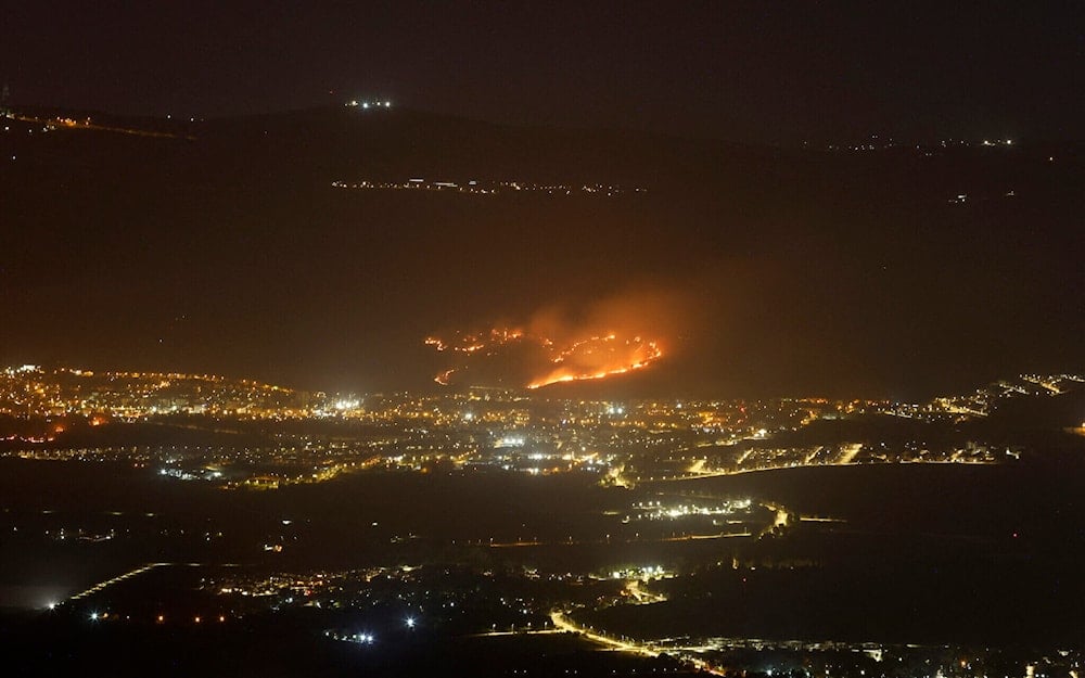 A fire breaks out as a result of rockets launched from Lebanon, next to the northern settlement of Kiryat Shmona, on May 10, 2024. (AFP)