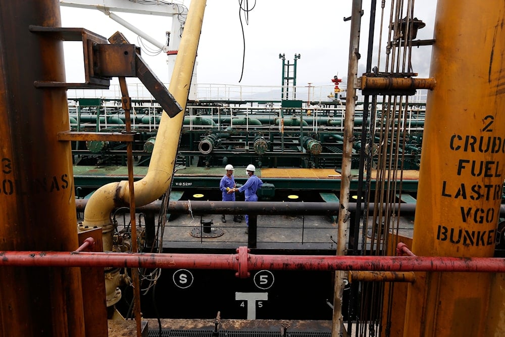 Crewmen speak aboard the Iranian oil tanker Fortune during its arrival at El Palito refinery near Puerto Cabello, Venezuela, May 25, 2020 (AP)