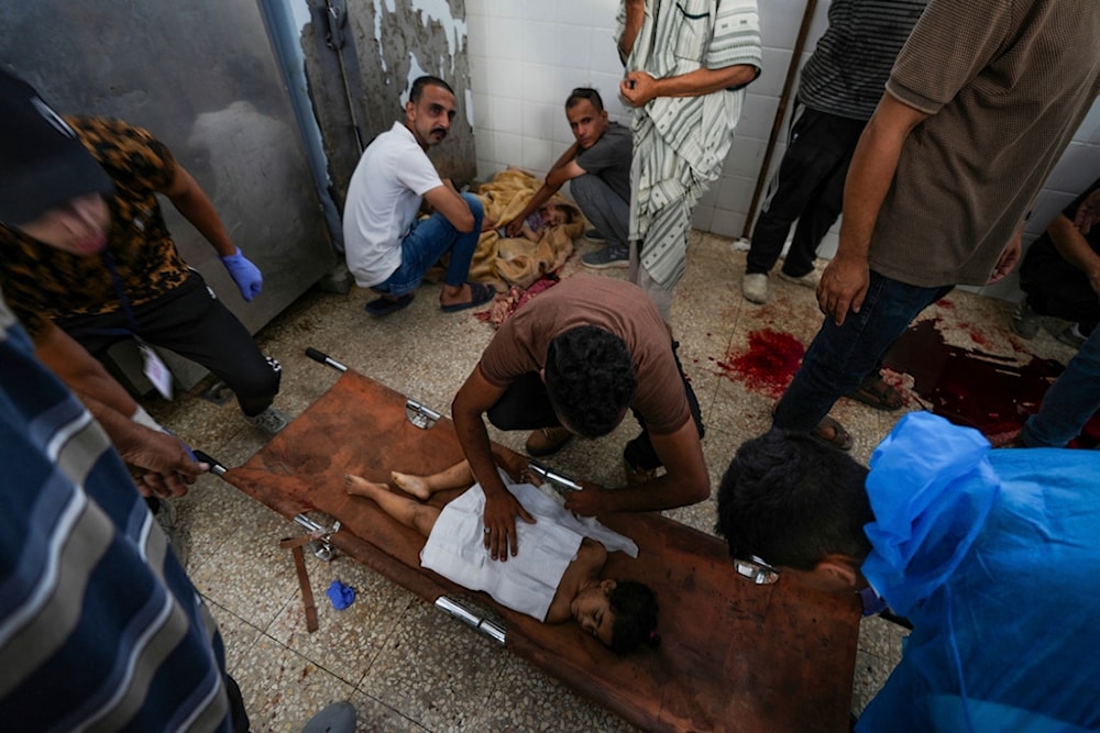 Palestinians mourn their relatives killed in the Israeli bombardment of the Gaza Strip in a hospital in Deir al Balah on Sunday, June 16, 2024. (AP)
