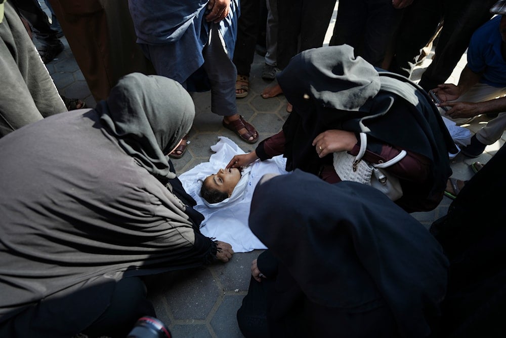 Palestinian women mourn a child killed in the Israeli bombardment of the Gaza Strip outside a hospital in Deir al Ballah on June 5, 2024. (AP)