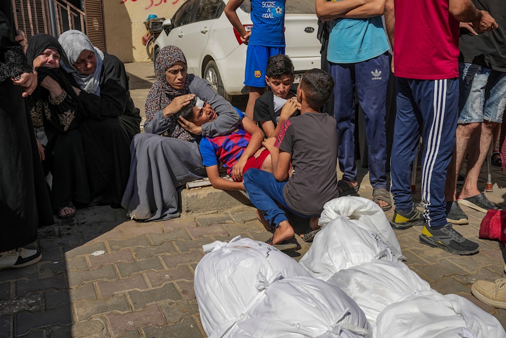 Palestinians mourn their relatives killed in the Israeli bombardment of the Gaza Strip in a hospital in Deir al-Balah on June 18, 2024. (AP)