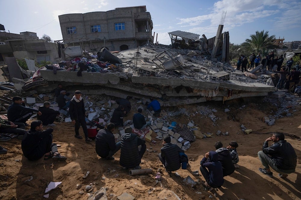 Palestinians search for bodies and survivors in the rubble of a residential building destroyed in an Israeli airstrike in Rafah, Gaza Strip, occupied Palestine on March 4, 2024 (AP)