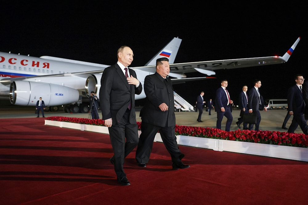 Russian President Vladimir Putin, right, and North Korea's leader Kim Jong Un walk at the Pyongyang Sunan International Airport outside Pyongyang, North Korea, on June 19, 2024. (AP)
