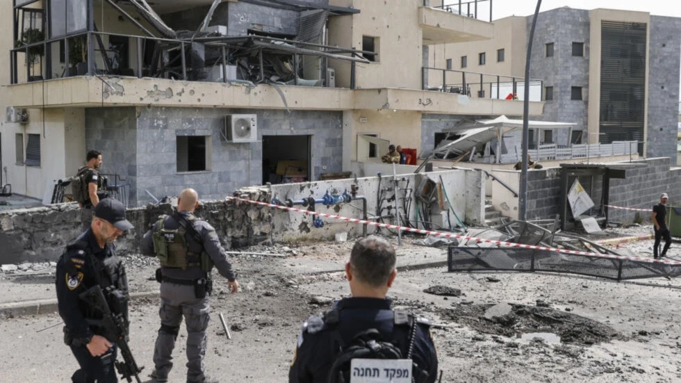 Israeli occupation forces inspect the area of the border settlement of Kiryat Shmona following a Hezbollah rocket (AFP)