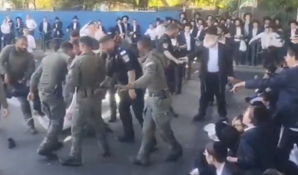 Israeli occupation police assault a Haredi Jew protesting the conscription law, June 2, 2024 (Screengrab)