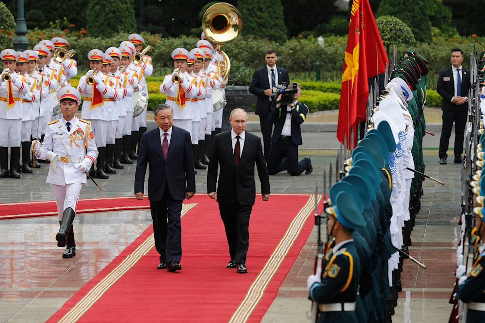 Vietnamese President To Lam, center left, and his Russian counterpart Vladimir Putin, center right, review the guard of honor at the Presidential Palace in Hanoi, Vietnam, on June 20, 2024. (AP)