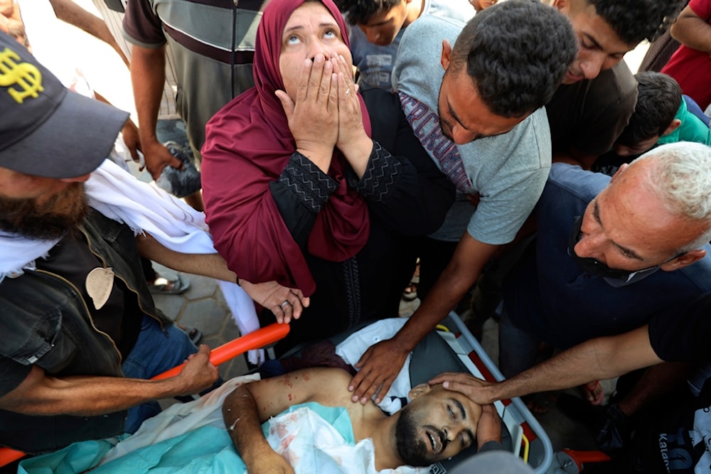 Palestinians mourn their relative Tamer Mohsen killed in the Israeli bombardment of Nuseirat refugee camp, at the morgue of al-Aqsa Martyrs hospital in Deir al Balah, central Gaza Strip, Wednesday, June 19, 2024. (AP)