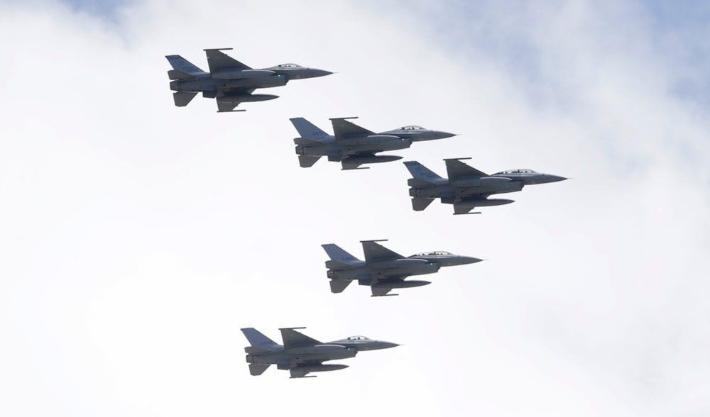 Taiwan’s F-16 fighter jets fly in close formation over the president’s office during National day celebrations in front of the Presidential Building in Taipei, Taiwan, October 10, 2021. (AP)