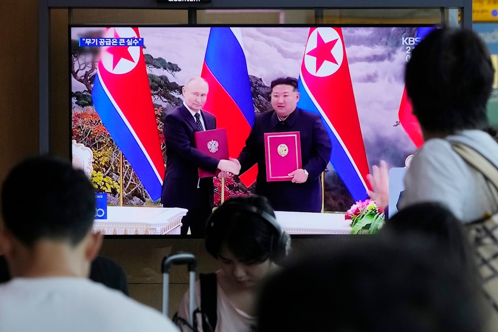 A TV screen showing DPRK leader Kim Jong Un and Russian President Vladimir Putin in Pyongyang, during a news program at the Seoul Railway Station in Seoul, South Korea, Friday, June 21, 2024 (AP)