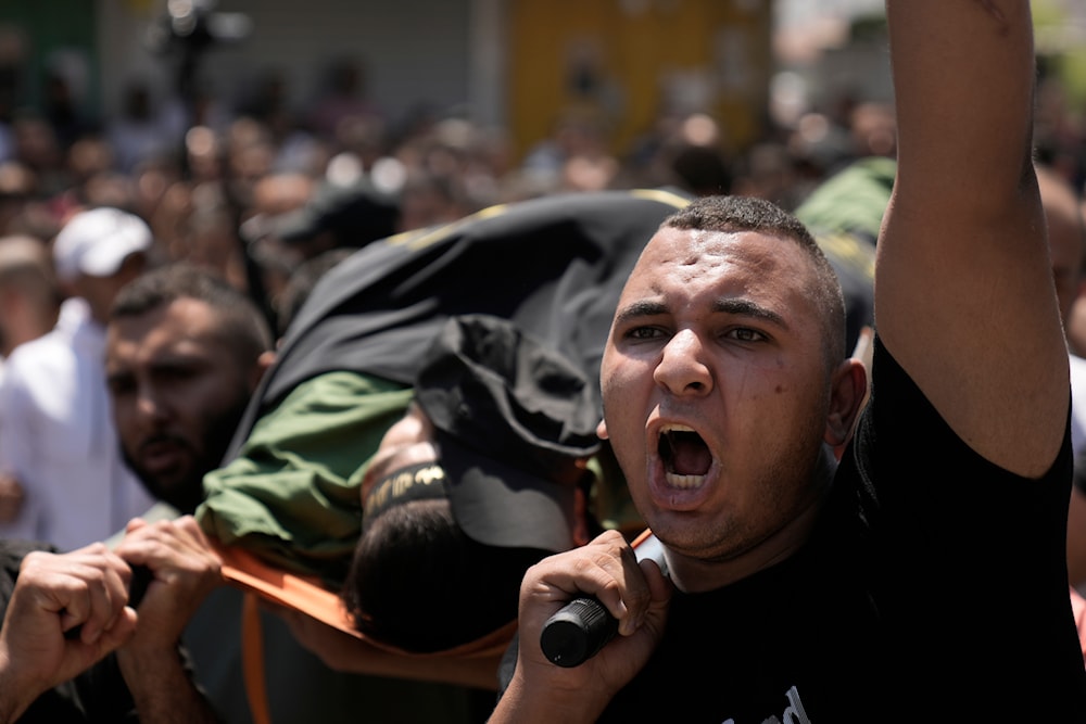 Mourners carry the body of Mustafa Marhi, a PIJ Resistance fighter killed in a raid by Israeli forces in the village of Kafr Dan, near the West Bank city of Jenin, occupied Palestine, June 12, 2024 (AP)