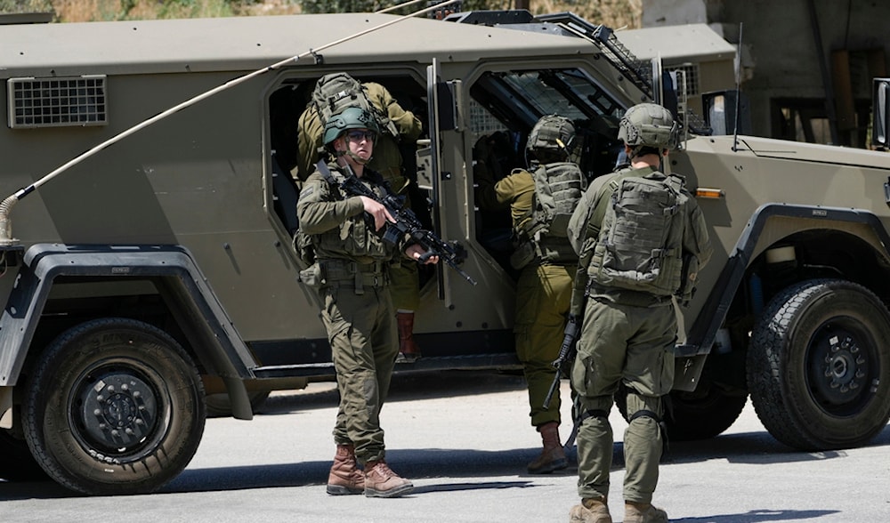IOF gather by their vehicles in the Palestinians Al Fara'a refugee camp in the occupied West Bank following  raid, Monday, June 10, 2024. (AP)