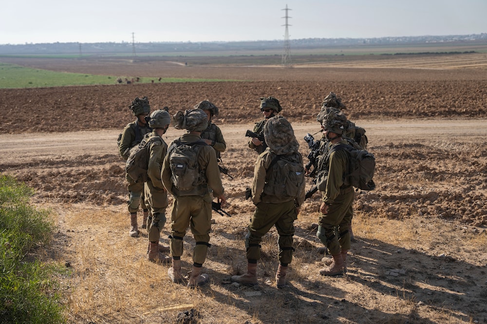 Israeli soldiers gather near the Gaza Strip border in southern occupied Palestine, June 13, 2024 (AP)