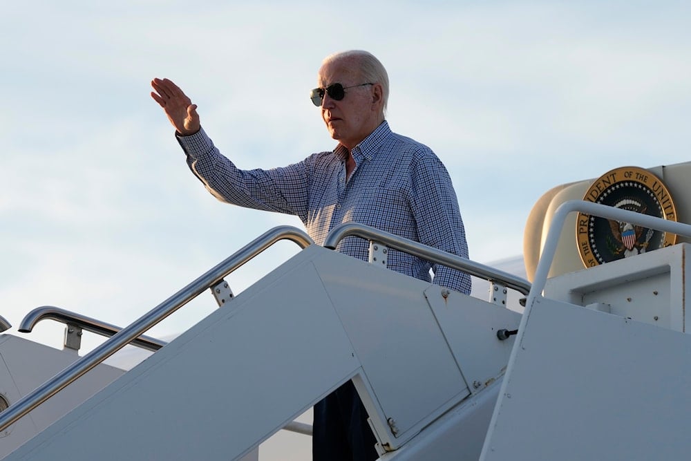 President Joe Biden waves as he boards Air Force One at Dover Air Force Base, Delaware, June 20, 2024 (AP)