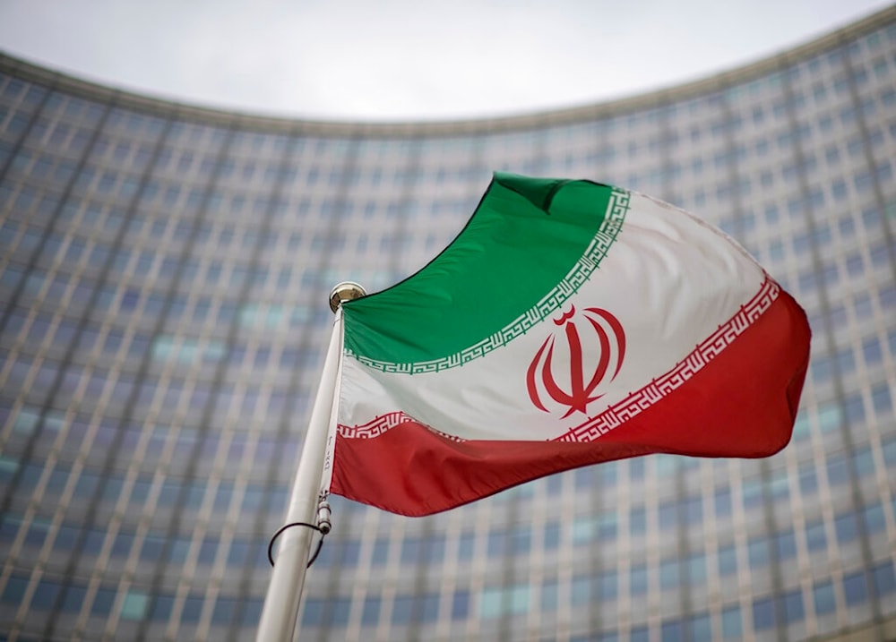 A national flag of Iran waves in front of the building of the International Atomic Energy Agency, IAEA, in Vienna, Austria, Friday, Dec. 17, 2021. (AP)