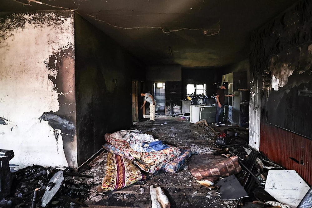 Illustrative: Palestinian villagers inspect the damage after Israeli settlers rampaged through the West Bank village of Duma in April, torching homes and vehicles (AFP)