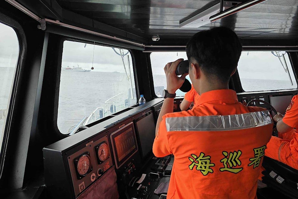 In this photo released by the Taiwan Coast Guard, a Taiwan Coast Guard member monitor Chinese navy vessel operating near the Pengjia Islet north of Taiwan on Thursday, May 23, 2024. (AP)