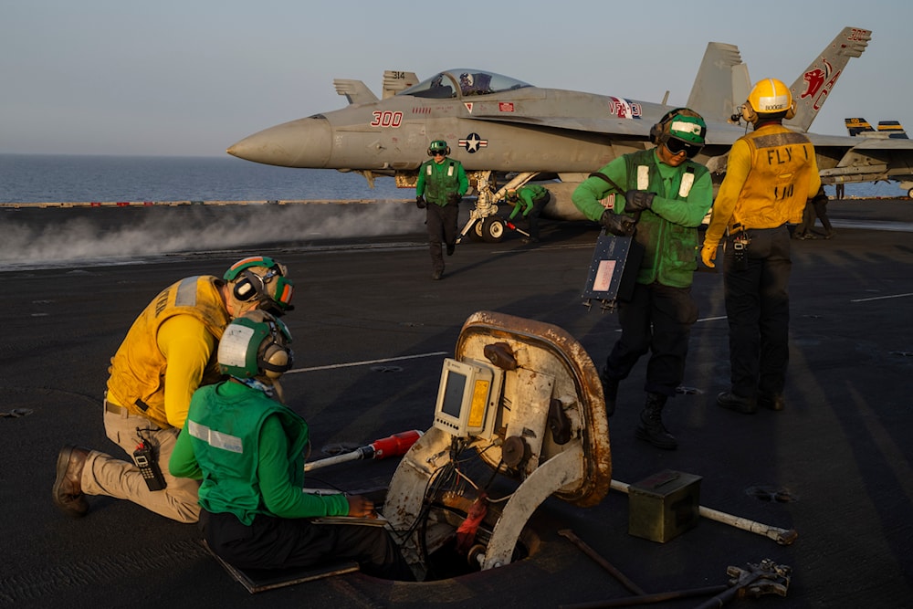 Crew members work during take off operations on the deck of the USS Dwight D. Eisenhower in the Red Sea on Tuesday, June 11, 2024. (AP)