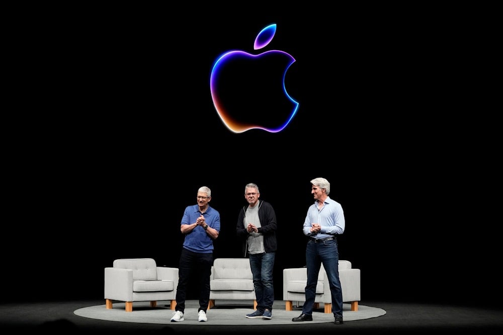 Apple CEO Tim Cook alongside two Apple VPs during an Apple event in Cupertino, Calif., Monday, June 10, 2024. (AP)