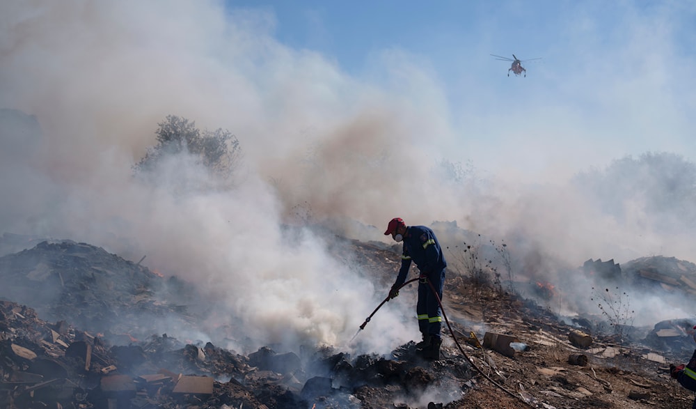 A firefighter tries to extinguish a fire burning in Koropi suburb, eastern part of Athens, Wednesday, June 19, 2024. (AP)