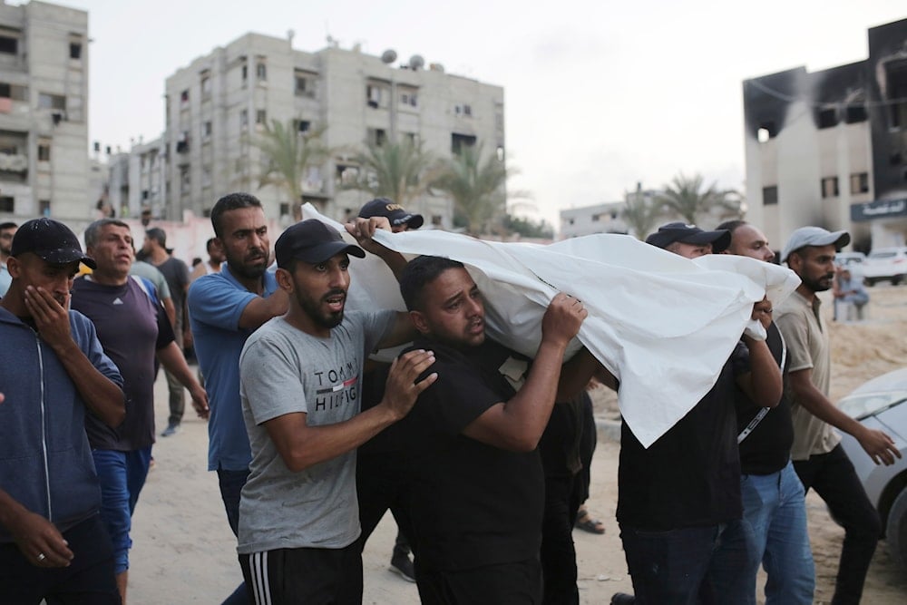 Palestinians carry a person killed by Israeli bombardment to their burial in Khan Younis, southern Gaza Strip, on June 21, 2024. (AP)