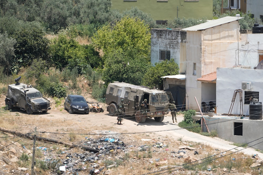 Israeli military soldiers are about to enter a house in the Palestinians Al Fara'a refugee camp in the occupied West Bank following an Israeli military raid, on June 10, 2024. (AP)