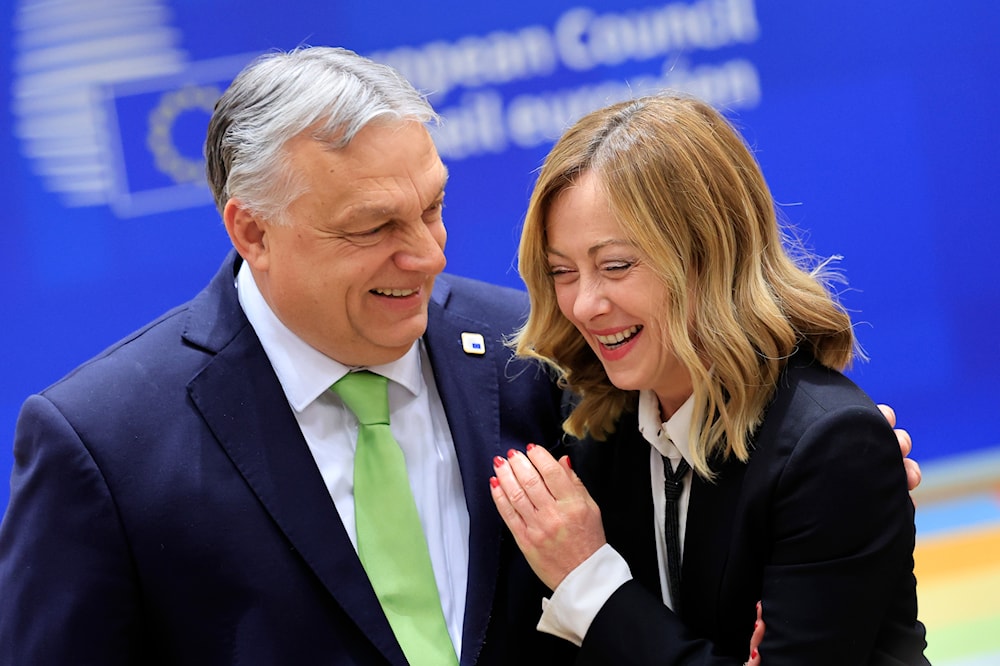 Hungary's Prime Minister Viktor Orban, left, speaks with Italy's Premier Giorgia Meloni during a round table meeting at an EU Summit in Brussels, on March 21, 2024. (AP)