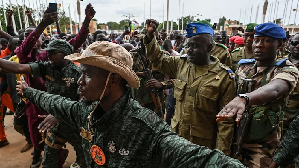 Niger's National Council for the Safeguard of the Homeland Colonel-Major Amadou Abdramane, second from right, is greeted by supporters upon his arrival at the Stade General Seyni Kountche in Niamey on August 6, 2023. (AFP/Getty Images