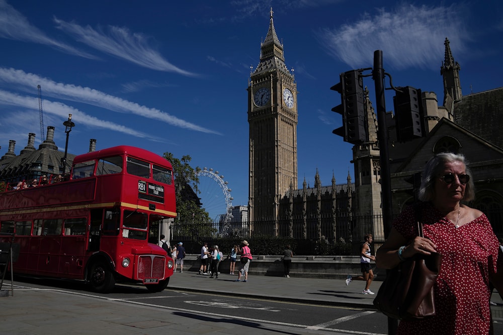 People walk outside the Houses of Parliament during a sunny day in London, on September 4, 2023. (AP)