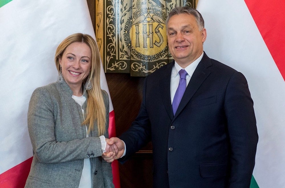 Giorgia Meloni, then-chairperson of the Brothers of Italy party, shakes hands with Hungarian PM Viktor Orban in the Parliament building, in Budapest, Hungary, February 28, 2018. (AP)