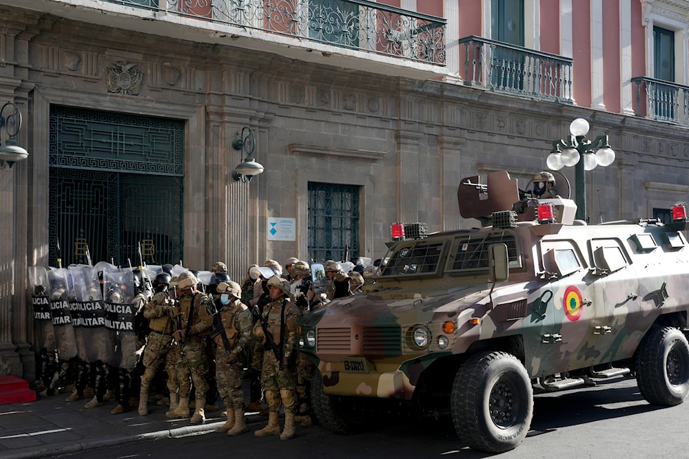 An armored vehicle and military police form outside the government palace at Plaza Murillo in La Paz, Bolivia, June 26, 2024 (AP)