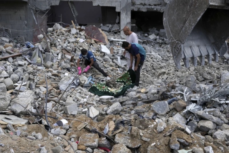 Palestinians recover the bodies of the al Meghari family including children killed in the Israeli bombardment of the Gaza strip in Bureij refugee camp, Gaza Strip, Tuesday, Nov. 14,2023. (AP)